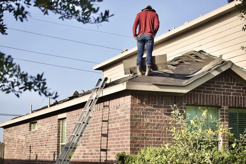 Professional roofer working on a residential roof in Chatfield